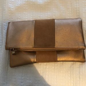 Rose gold clutch with magnetic closure.